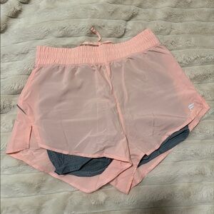 Layered Fabletics pink shorts